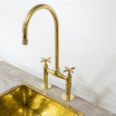 Unlacquered brass bridge kitchen faucet – modern high-arc spout, front view