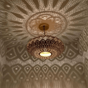 Close-up of hand-pierced lotus pattern on brass flush mount ceiling lamp – Brass For Homes