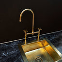 Polished brass bridge faucet – close-up of handle and bridge detail