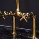 Unlacquered brass bridge faucet curved legs – side view showing cross handles