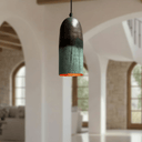 Close-up of oxidized green-to-teal copper cylinder pendant surface texture — Brass For Homes