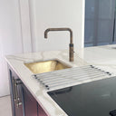Handcrafted unlacquered brass kitchen sink – close-up of hand-hammered finish